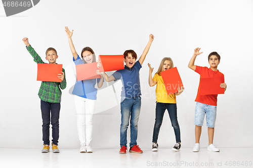 Image of Group of children with red banners isolated in white