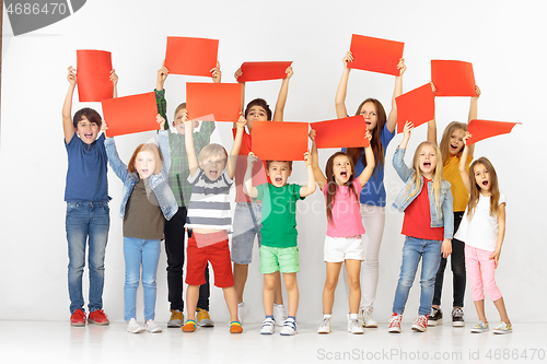 Image of Group of children with a red banners isolated in white