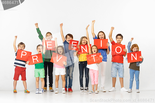 Image of Group of children with a red banners isolated in white