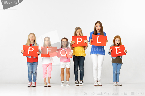 Image of People. Group of children with red banners isolated in white