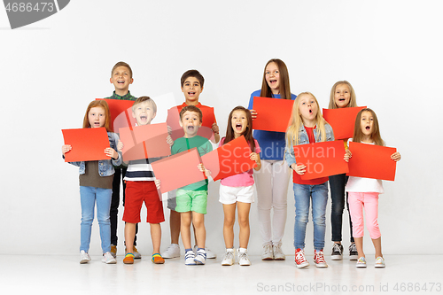 Image of Group of children with a red banners isolated in white