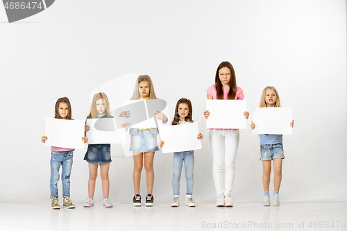 Image of Group of children with a white banners isolated in white