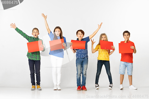 Image of Group of children with red banners isolated in white