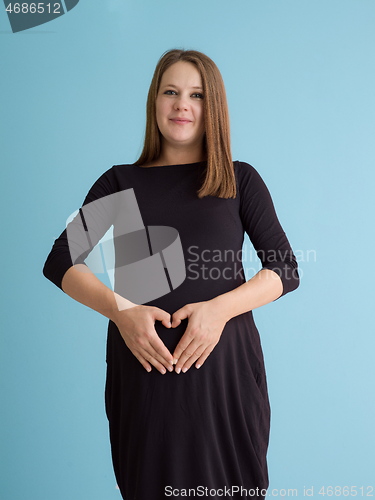 Image of Portrait of pregnant woman over blue background