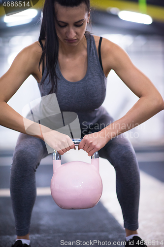 Image of woman exercise with fitness kettlebell