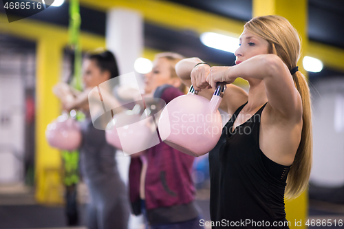 Image of athletes doing exercises with kettlebells