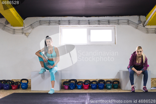 Image of young athletes women sitting and relaxing