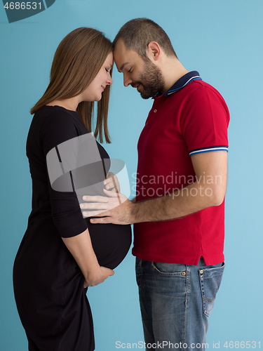 Image of pregnant couple  isolated over blue background