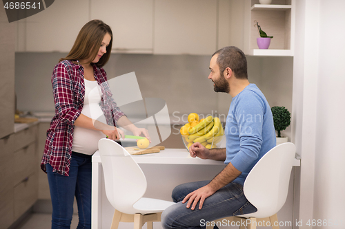 Image of couple cooking food fruit lemon juice at kitchen