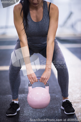 Image of woman exercise with fitness kettlebell