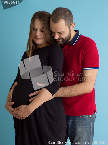 Image of pregnant couple  isolated over blue background