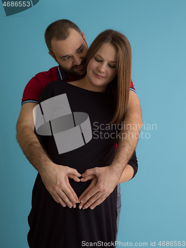 Image of pregnant couple  isolated over blue background