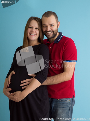 Image of pregnant couple  isolated over blue background