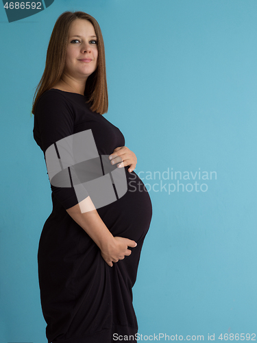 Image of Portrait of pregnant woman over blue background