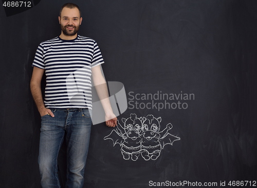 Image of future dad drawing his imaginations on chalk board