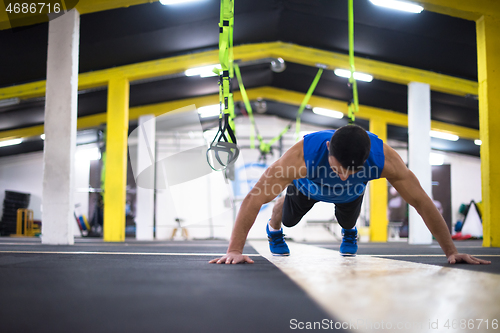 Image of Young  man doing pushups