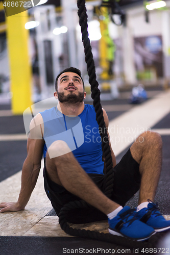 Image of man relaxing before rope climbing