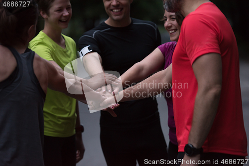 Image of runners giving high five to each other