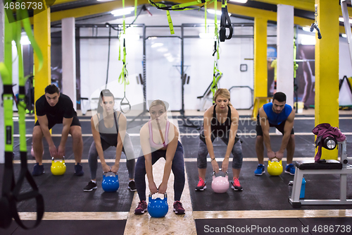 Image of athletes doing exercises with kettlebells