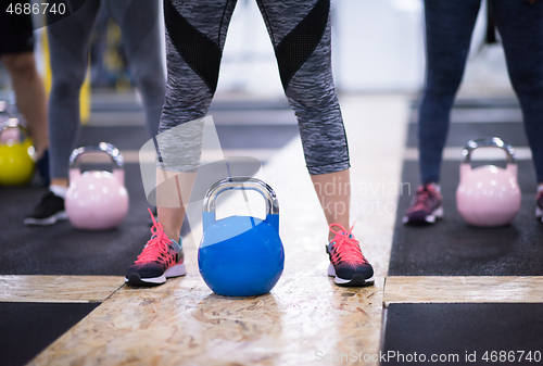 Image of athletes doing exercises with kettlebells