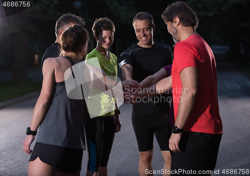 Image of runners giving high five to each other