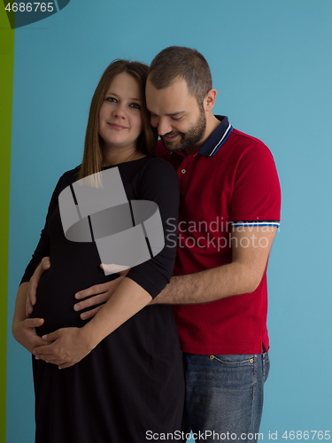 Image of pregnant couple  isolated over blue background