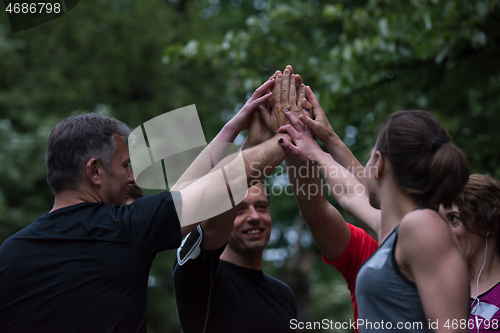 Image of runners giving high five to each other