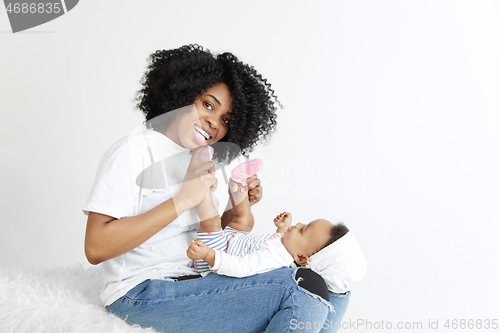 Image of Portrait of beautiful african woman holding on hands her little baby