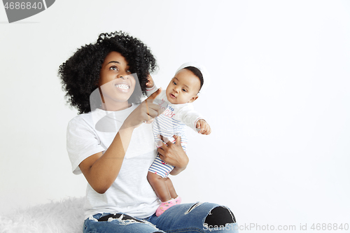 Image of Portrait of beautiful african woman holding on hands her little baby