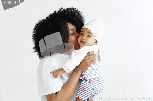 Image of Portrait of beautiful african woman holding on hands her little baby