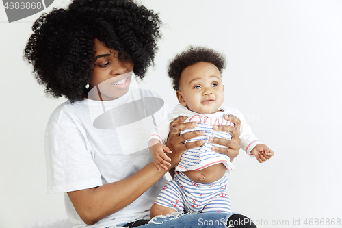 Image of Portrait of beautiful african woman holding on hands her little baby