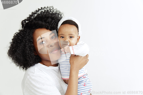 Image of Portrait of beautiful african woman holding on hands her little baby