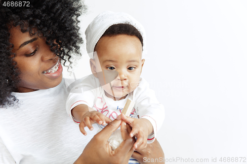 Image of Portrait of beautiful african woman holding on hands her little baby