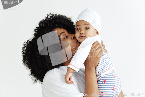 Image of Portrait of beautiful african woman holding on hands her little baby