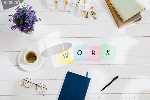 Image of WORK. Message at colorful note papers on a desk background.