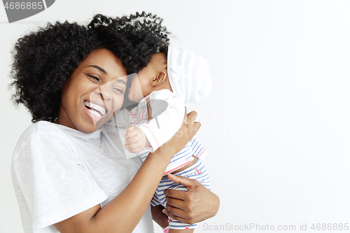 Image of Portrait of beautiful african woman holding on hands her little baby