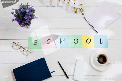 Image of Stationery and word SCHOOL made of letters on wooden background