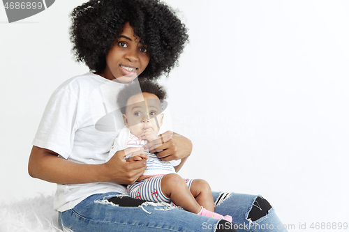 Image of Portrait of beautiful african woman holding on hands her little baby