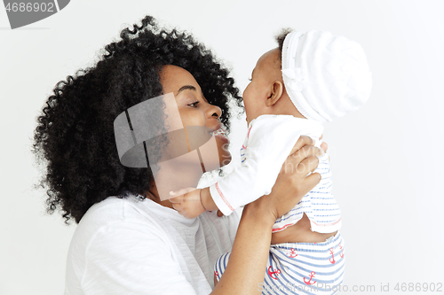 Image of Portrait of beautiful african woman holding on hands her little baby