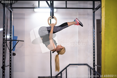 Image of woman working out on gymnastic rings