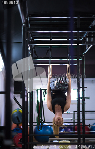 Image of woman working out on gymnastic rings