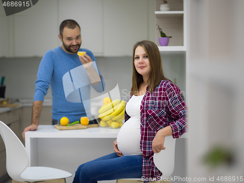 Image of couple cooking food fruit lemon juice at kitchen