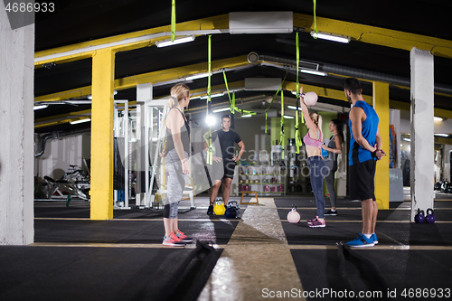 Image of athletes doing exercises with kettlebells