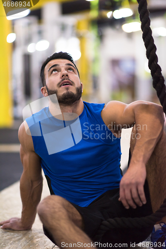 Image of man relaxing before rope climbing