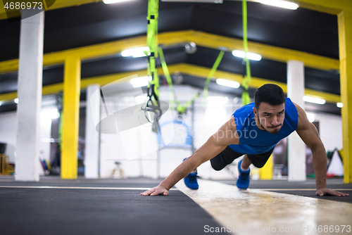 Image of Young  man doing pushups