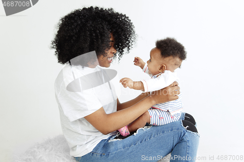 Image of Portrait of beautiful african woman holding on hands her little baby