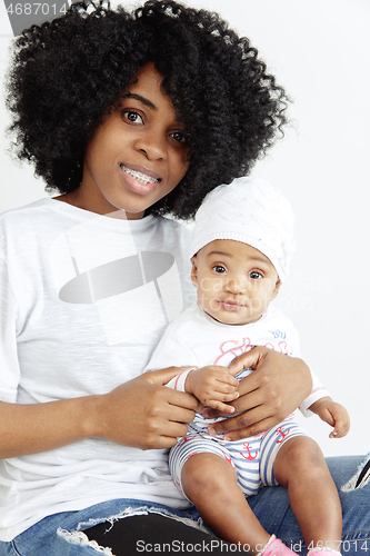 Image of Portrait of beautiful african woman holding on hands her little 