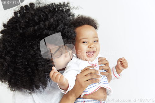 Image of Portrait of beautiful african woman holding on hands her little baby