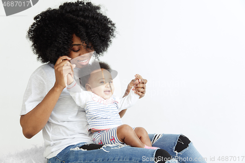 Image of Portrait of beautiful african woman holding on hands her little baby