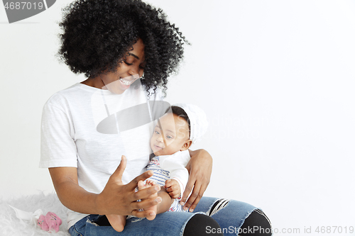 Image of Portrait of beautiful african woman holding on hands her little baby